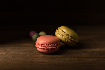 Macaron, Pink and Green stacked Macarons on wooden table, breakfast in morning light