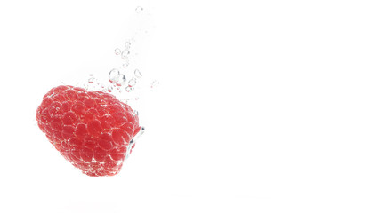 Blueberries falling into a water isolated on black background
