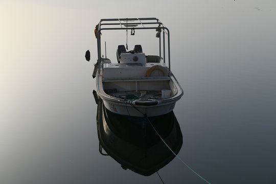 white powerboat on body of water