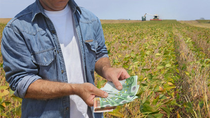 Agricultural concept, farmer, money and soybean field harvest