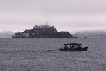 Morning fog clears around Alcatraz Island in San Francisco