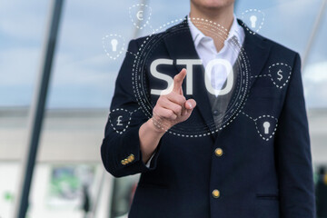 Security Token Offering STO cryptocurrency and blockchain concept, businessman pressing virtual graphics on virtual screens