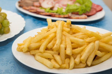 Set the table in the restaurant, different dishes on a blue tablecloth