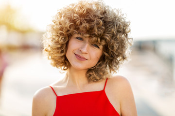 Portrait of young woman with curly hair