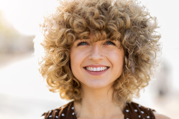 Portrait of young woman with curly hair