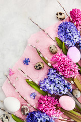 Beautiful hyacinths, willow and  Easter eggs on light background, top view, spring holiday concept