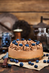 Delicious homemade chocolate cheesecake decorated with fresh blueberries