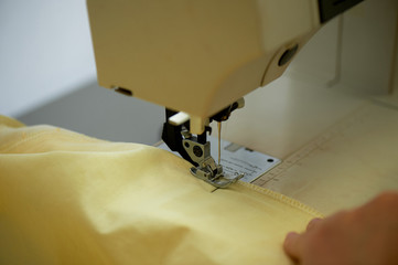 Sewing clothes on a typewriter, close. Atelier, individual approach.