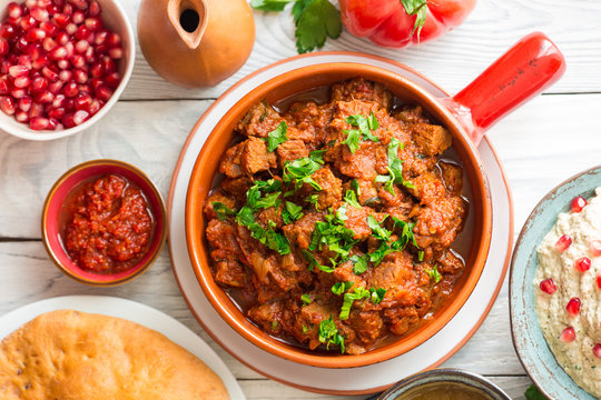 Georgian cuisine- Adjarian Khachapuri with cheese sulguni, chashushuli - a beaf and tomato stew, Pkhali from eggplants and walnuts, adjika, Tkemali  souse.