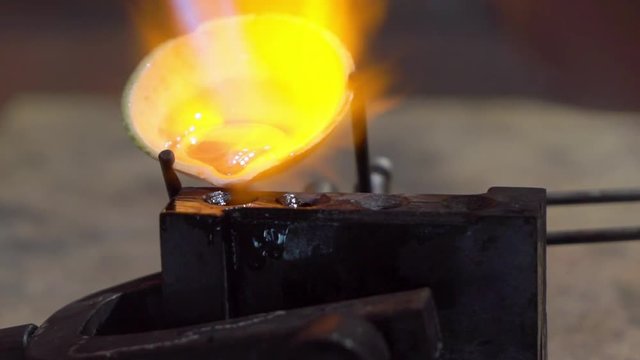 Goldsmith working with a unfinished ring using fire