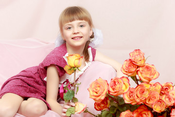 Little girl with a bouquet of tea roses.