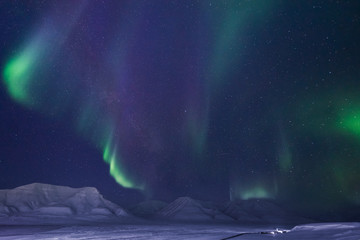 The polar arctic Northern lights aurora borealis sky star in Norway travel Svalbard in Longyearbyen city the moon mountains