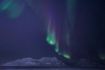 The polar arctic Northern lights aurora borealis sky star in Norway travel Svalbard in Longyearbyen city the moon mountains