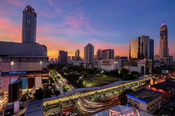 Bangkok business district with the public park area in the foreground at sunset time