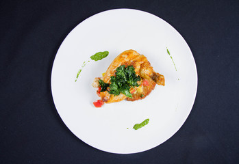 Chicken served with potato pancake some vegetables decorated with pea mash