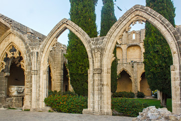 Fototapeta na wymiar Ruins of the Abbey of Bellapais in the Northern Cyprus. Bellapais Abbey is the ruin of a monastery built by Canons Regular in the 13th century near the Kyrenia.