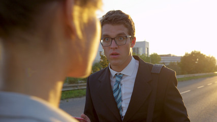 LENS FLARE: Young businessman is shocked to see a gorgeous woman in gray suit.