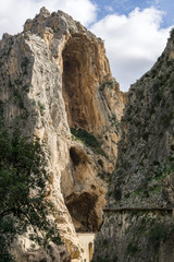 Obraz premium Caminito del rey hike and valley. Mountain path along steep cliffs and an enormous heights.