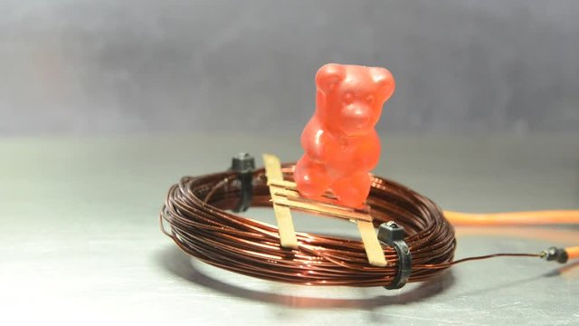 A coil supplied with an alternating current hovers over a metal plate.  As can be seen the coil can even carry a "payload".