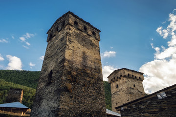 Fototapeta na wymiar Walls of stone ancient svan towers, view from the bottom