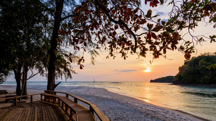 Fototapeta na wymiar Beautiful nature landscape of colorful the sun on the sky at Tarutao island beach during the sunset over the Andaman Sea under the tree shadow, Tarutao National Park, Satun, Thailand