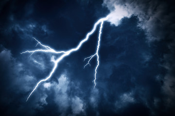 Lightning strike on the cloudy dark sky.