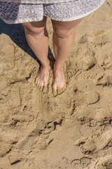 female feet on the sand