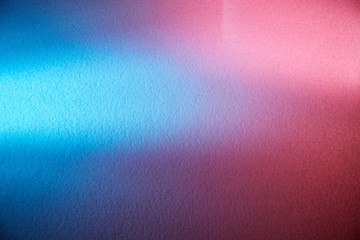 On a gradient pink and blue background white volumetric rays of light