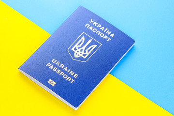 Ukrainian biometric passport on background of Ukrainian flag. Passport on background of national flag. Document for traveling abroad, concept