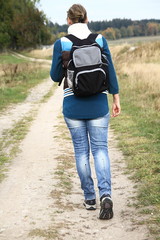 woman with rucksack walking in the country