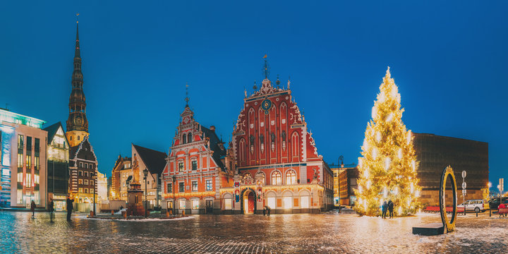 Riga, Latvia. Panorama Of Town Hall Square, Popular Place With Famous Landmarks On It In Night Illumination In Winter Twilight. Winter New Year Christmas Holiday Season