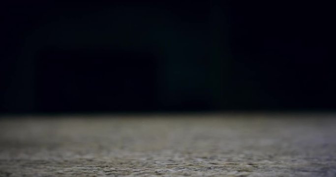 Close up of a hand grabbing a pint of beer and pulling it off of a bar with left hand