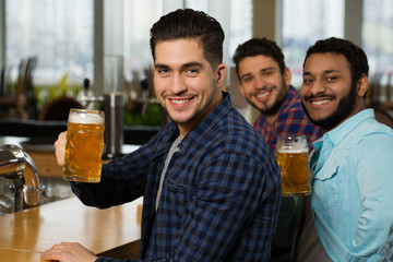 Join us at the pub. Shot of a group of friends enjoying drinks at the bar