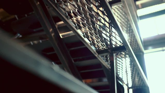 rays of sunlight through metal grate at construction site in modern loft building. slow motion.