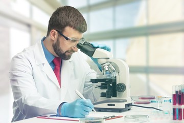 Young male scientist Working with Microscope