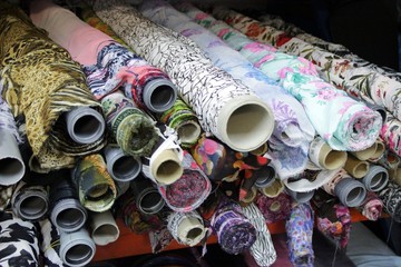 rolls of colored fabrics in the fabric store, with ornaments