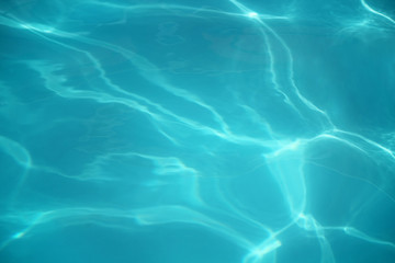  The texture of the water at sunset. The concept of ecology, cleanliness, recreation, travel. Water in motion, top view, selective focus.