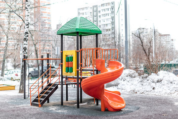 Ginger and green playground outside at winter time. Moscow city.