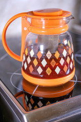 the image of the teapot on the ceramic stove
