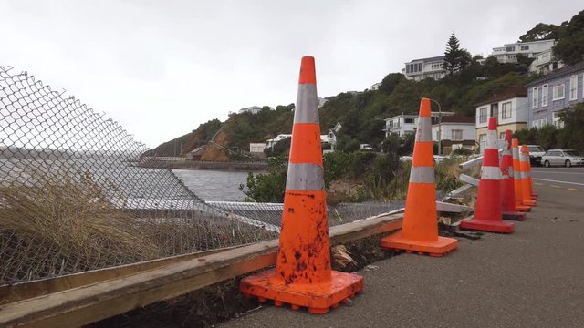 Car accident site, broken fences and warning cones in early morning, pan shot