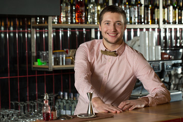 Greeting guests. Horizontal shot of a handsome and stylish bartender.