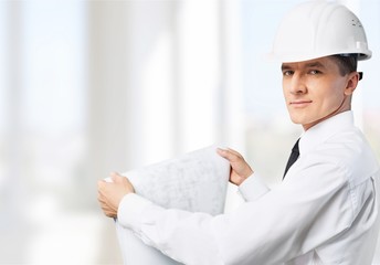 Young business man in suit and white helmet