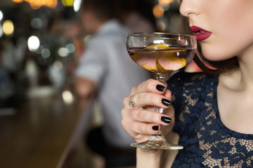 Style of life.  Unique beauty woman looking confident drinking at the bar.