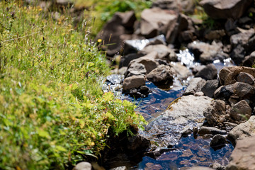 Fototapeta na wymiar Small stream of water on a sunny day
