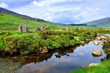 Ruined mining building along a picturesque creek in the hills of Wicklow Mountains National Park,...