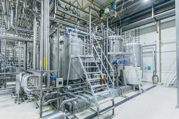 Modern brewery interior. Filtration vats, pipeline, valves and other equipment of beer production line