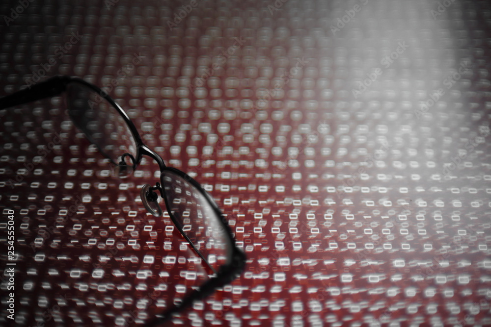 Poster computer hacker. red dangerous code breach into red binary code with glasses place over led panel. virus, cyber threat and computer internet system failure concepts.