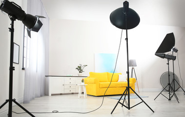 Example of living room interior design and professional equipment in photo studio