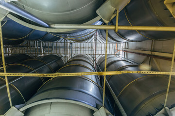 Modern brewery production line. Large vats for beer  fermentation and maturation. Bottom view