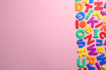 Plastic magnetic letters on color background, top view with space for text